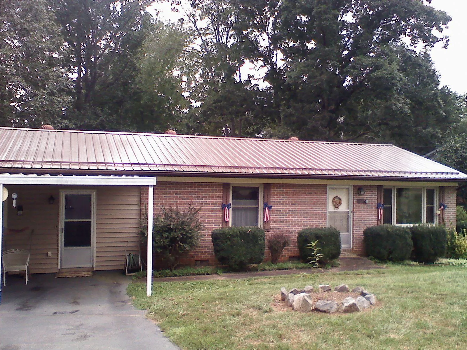 Bronze metal roof and carport on a brick ranch home — Roof Repair work by our crew in Brockton